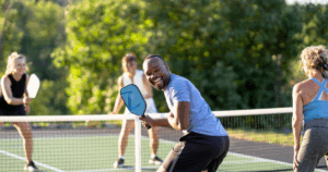 Man playing pickleball with safe posture for spine health